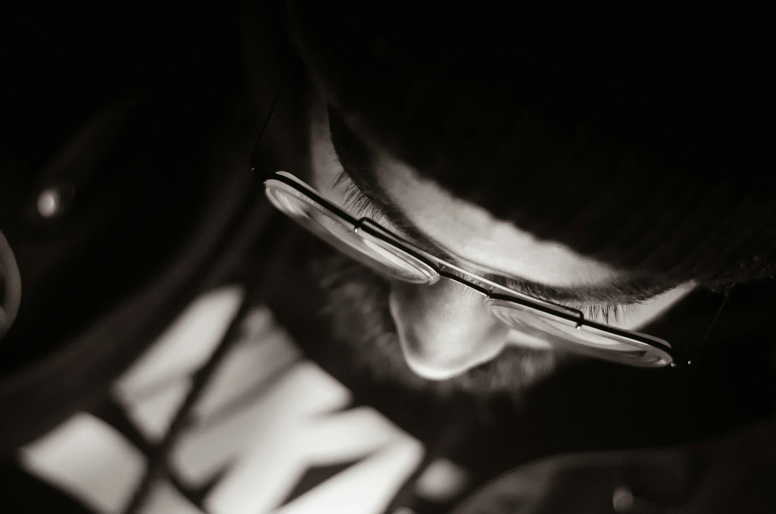 macro photography of person wearing eyeglasses